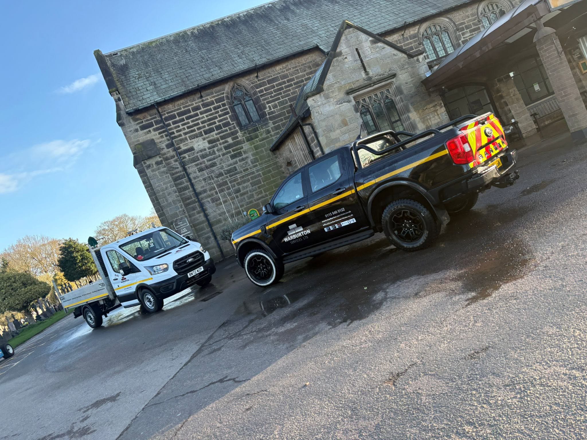 Warburton Services vehicles on site outside a stone chapel